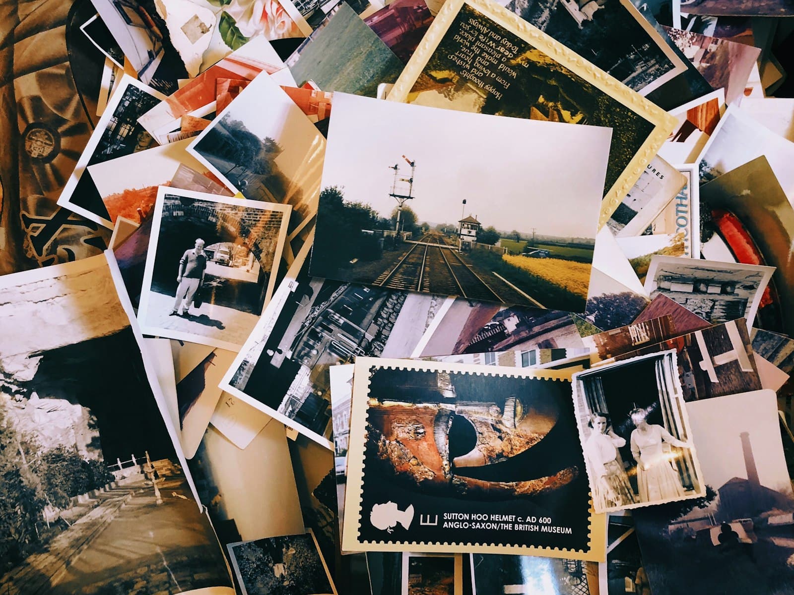Une pile de vieilles photos et de cartes postales posées les unes sur les autres, évoquant les souvenirs